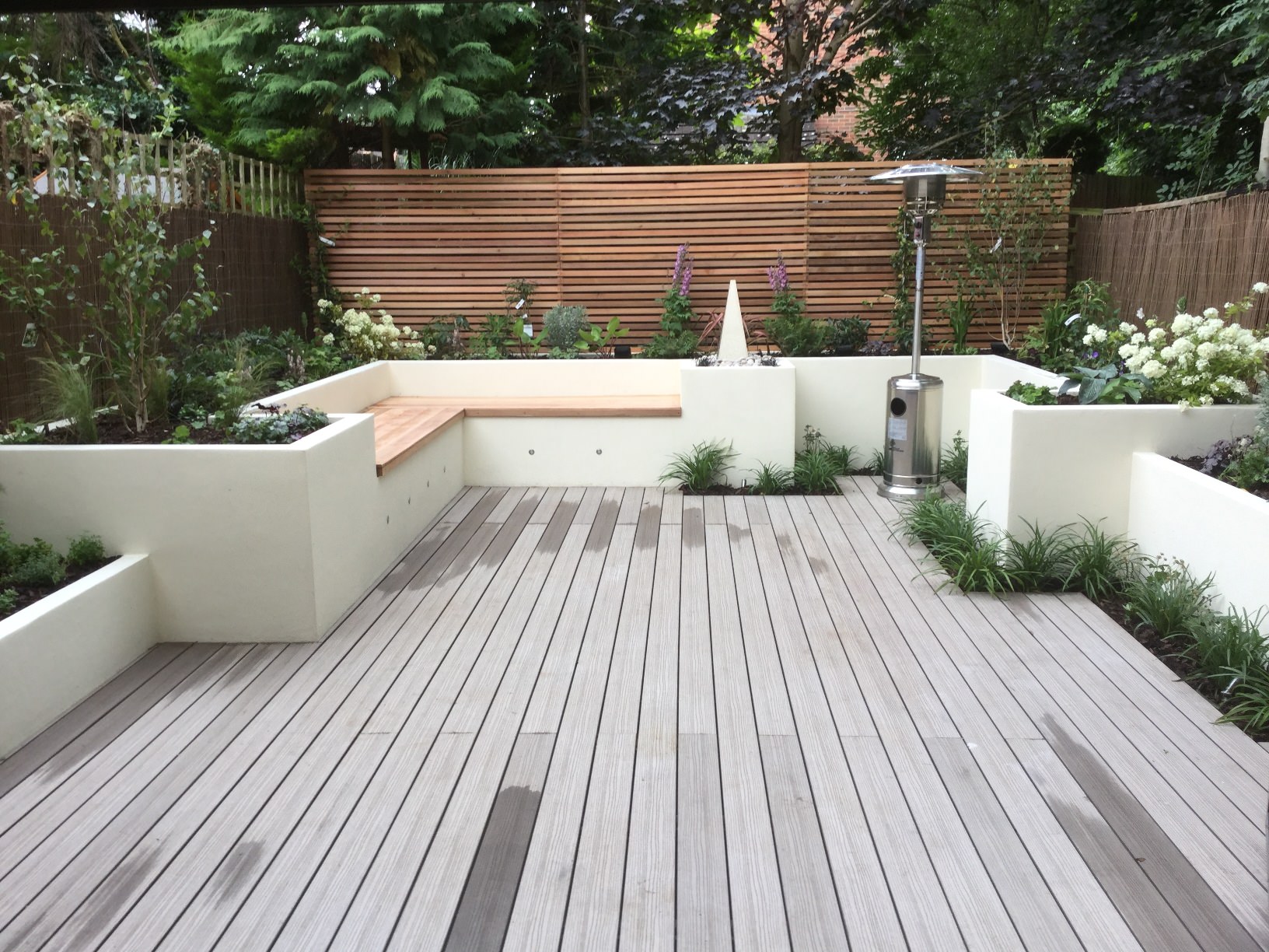 Courtyard garden with natural stone paving and Mediterranean planting